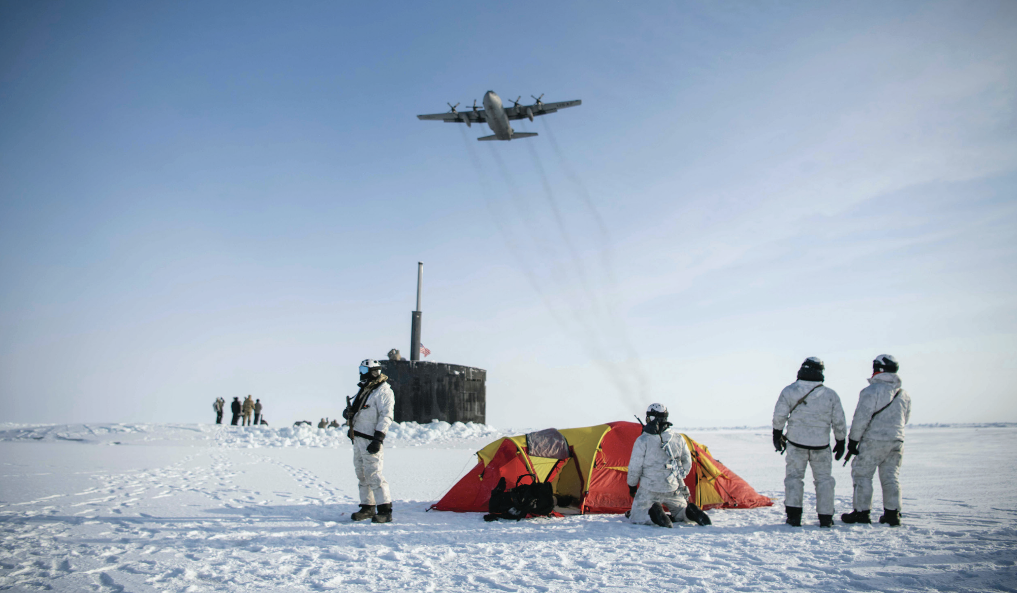 Air Force C-130 Hercules flies over group of Navy SEALS, Norwegian naval special operations commandos, and attack submarine USS Hamptonduring exercise Arctic Edge, March 9, 2024 (U.S. Navy/Jeff Atherton)